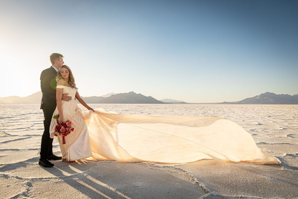 Bride’s wedding dress flowing in the breeze during Salt Flats elopement shoot