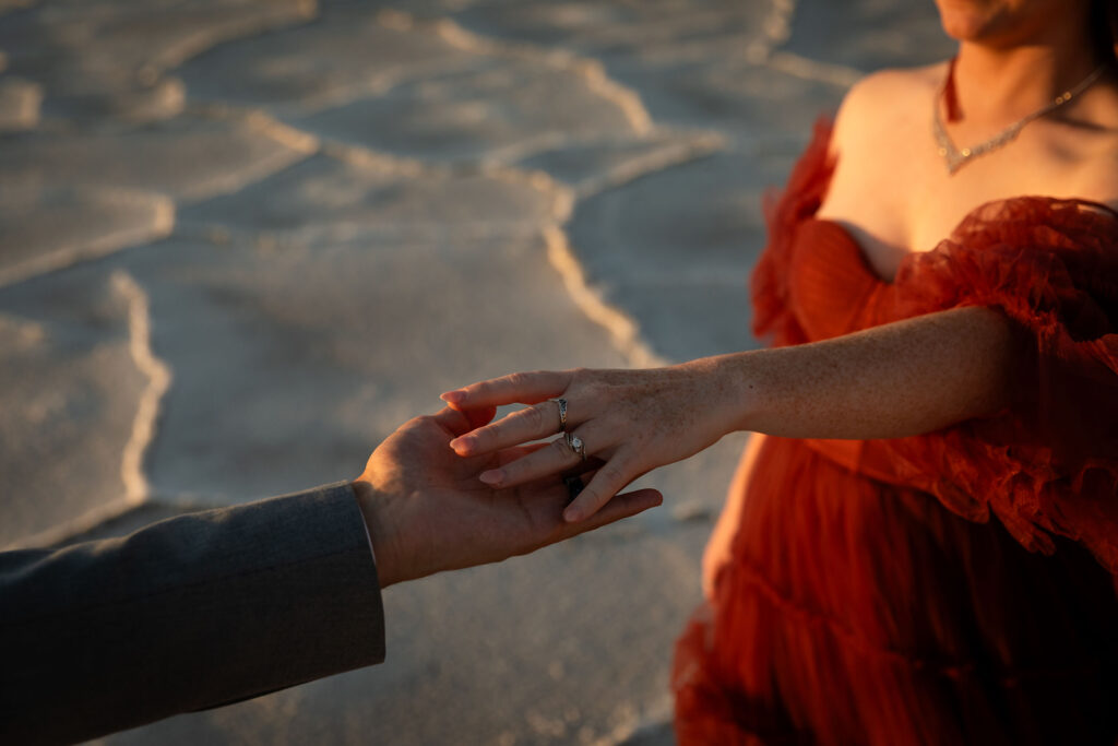 Close-up of wedding rings styled on Bonneville Salt Flats surface