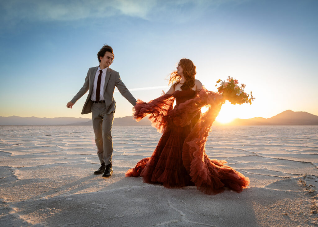 Romantic elopement photo of couple in Utah’s Salt Flats with dramatic wide-open skies