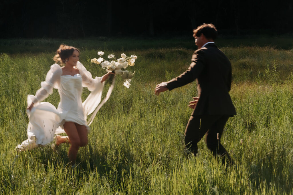 Wedding photoshoot with bride and groom standing in wildflower field