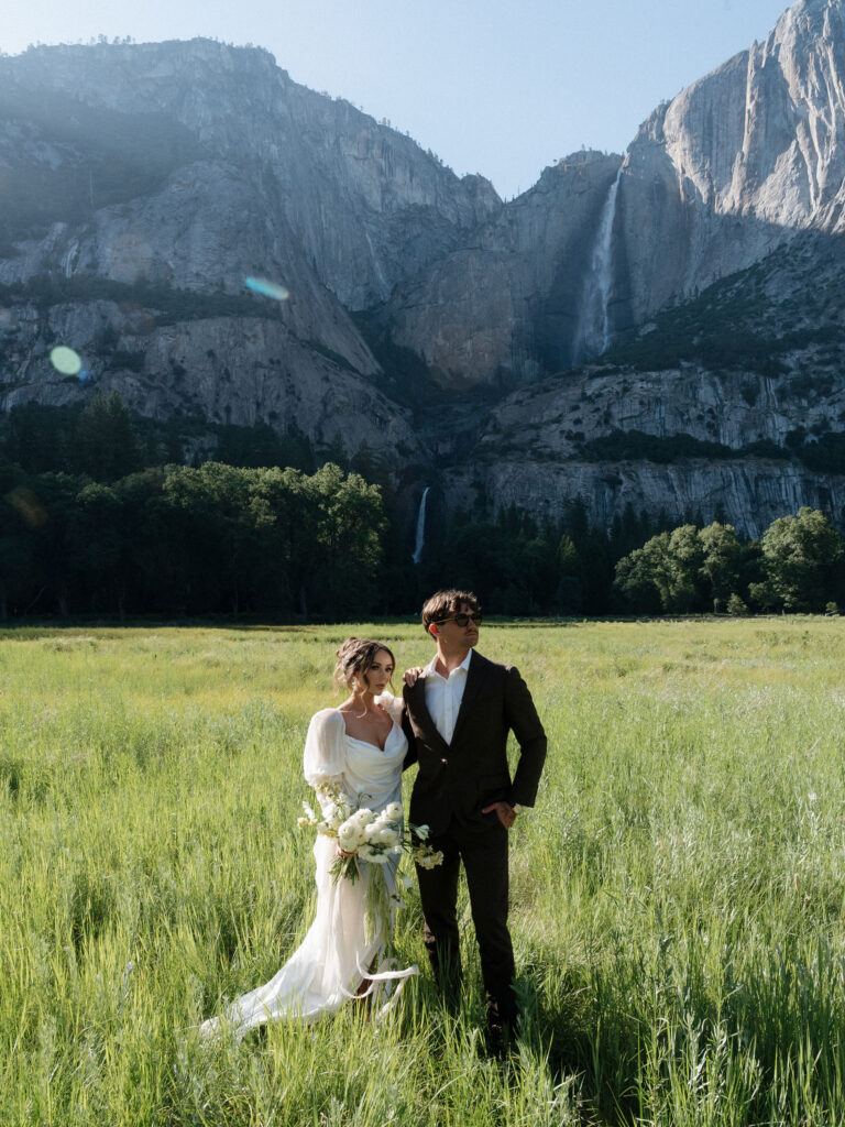 Wedding portraits in Yosemite Valley meadow with towering granite cliffs