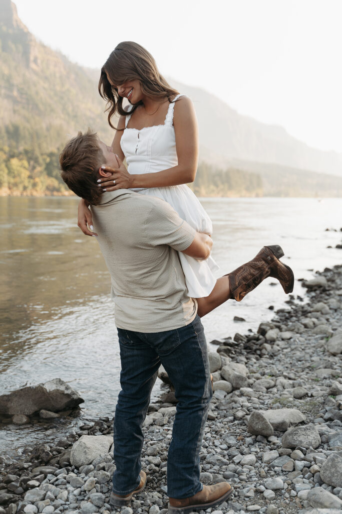 Scenic engagement session with river and greenery in the background