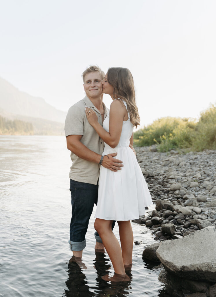 Scenic engagement session with river and greenery in the background