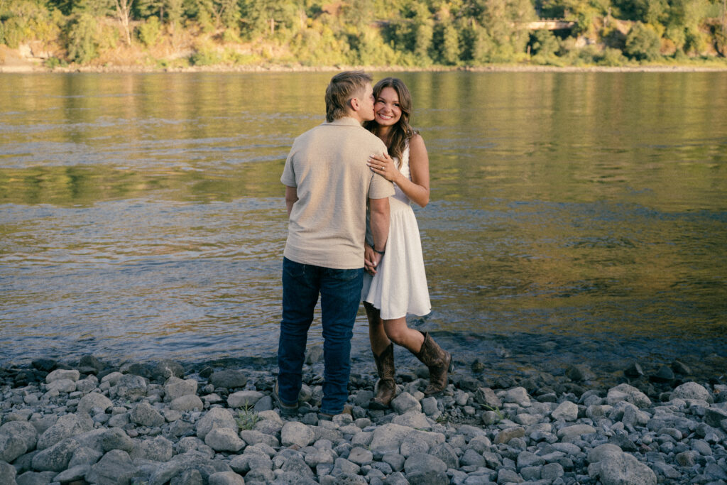 Couple holding hands by the Columbia River Gorge during engagement session