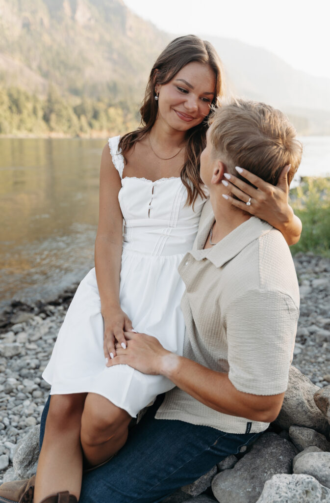 Bride and groom-to-be sharing a tender moment by the river