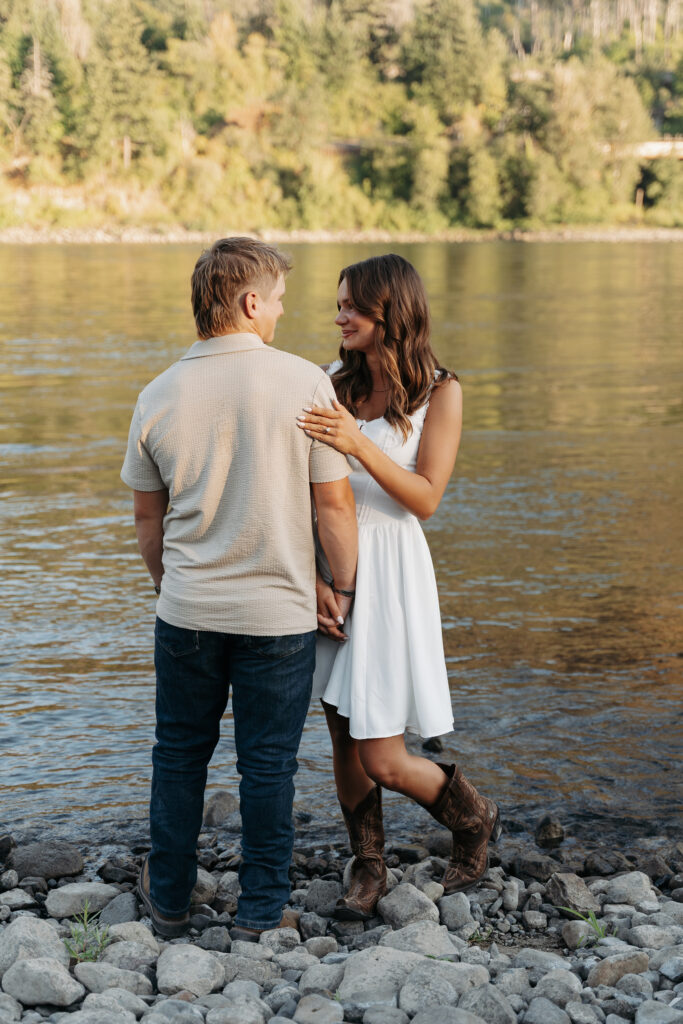 Couple dressed in casual summer outfits posing by the Columbia River Gorge