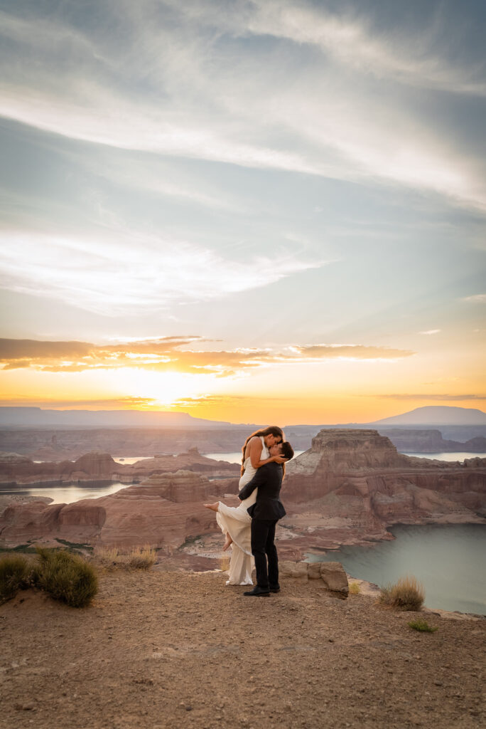Intimate elopement portrait with glowing cliffs of Lake Powell.