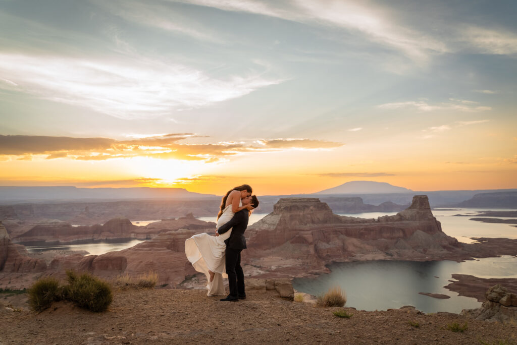 Intimate elopement portrait with glowing cliffs of Lake Powell.