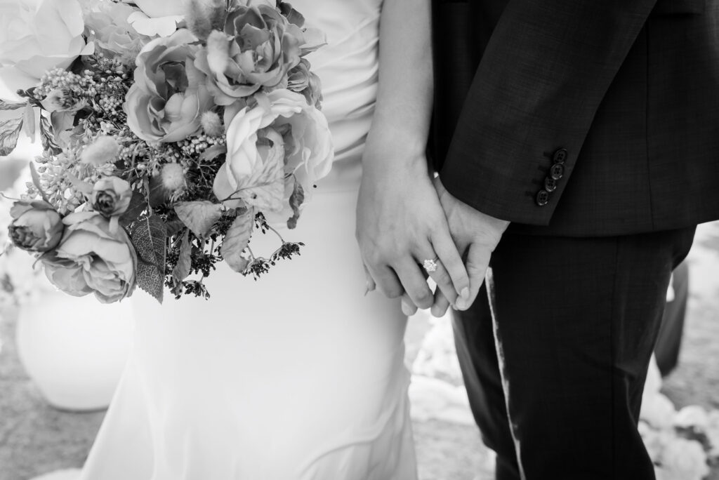 Bride and groom holding hands.