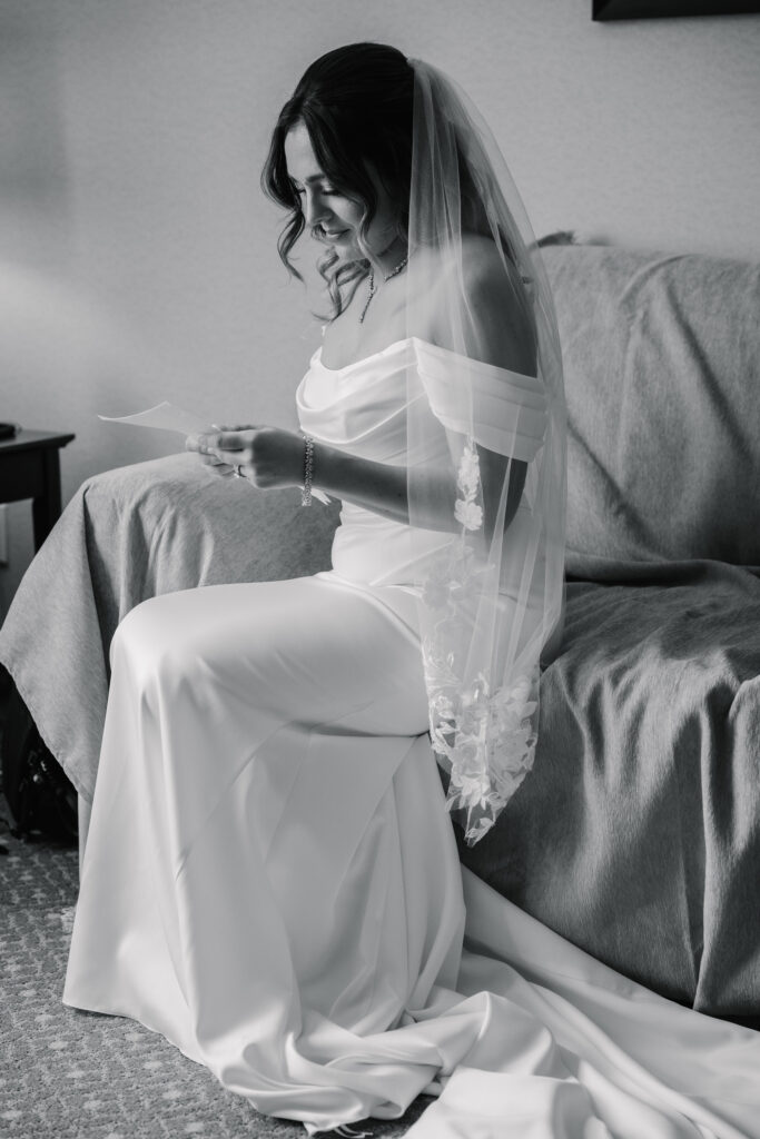 Bride reading a love letter during quiet pre-ceremony moments