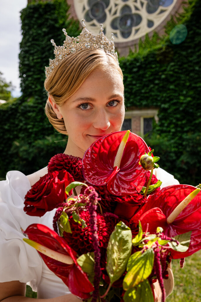 Bride smiling while holding her bouquet close to her heart