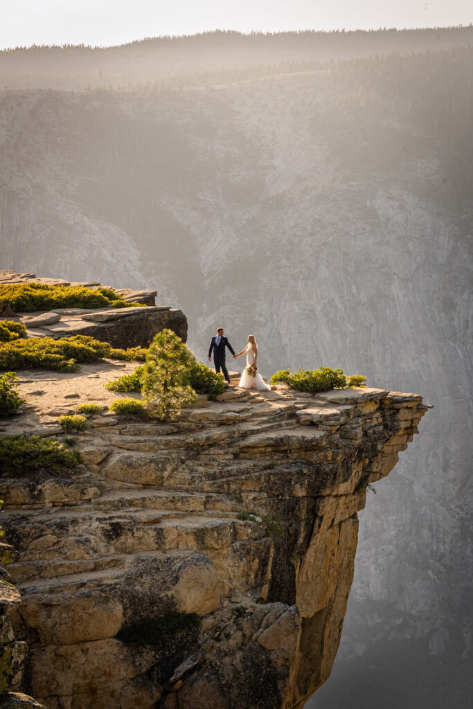 Bride and groom by the cliffs during golden hour