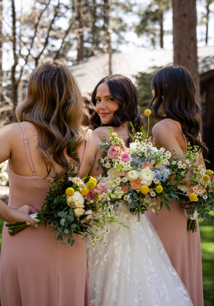 Bride surrounded by bridesmaids in matching dresses