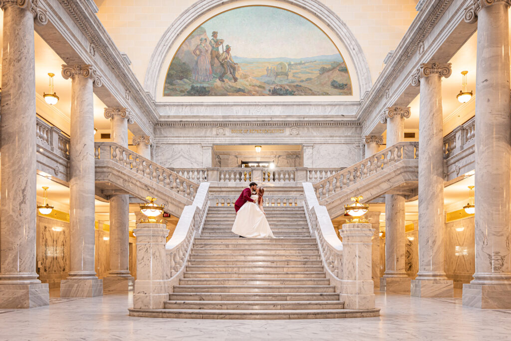 Couple sharing a moment on the marble staircase at the Utah State Capitol during their courthouse elopement.