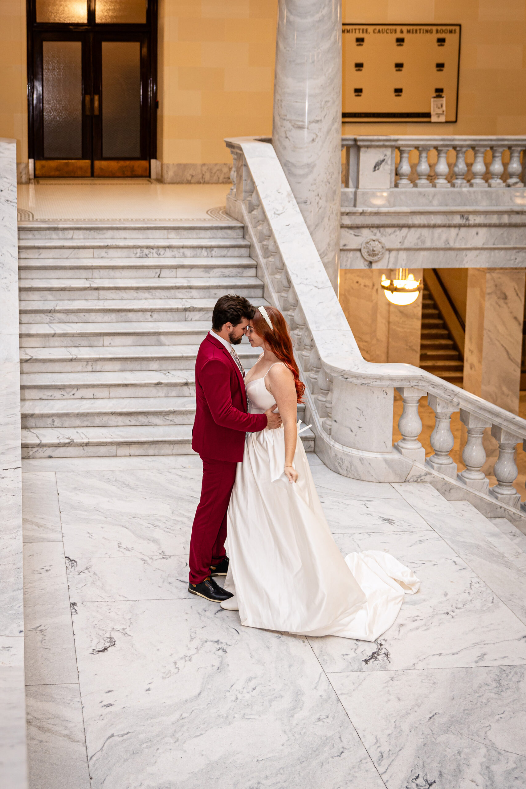 Bride and groom sharing a quiet moment on the staircase during their elegant Salt Lake City courthouse elopement.