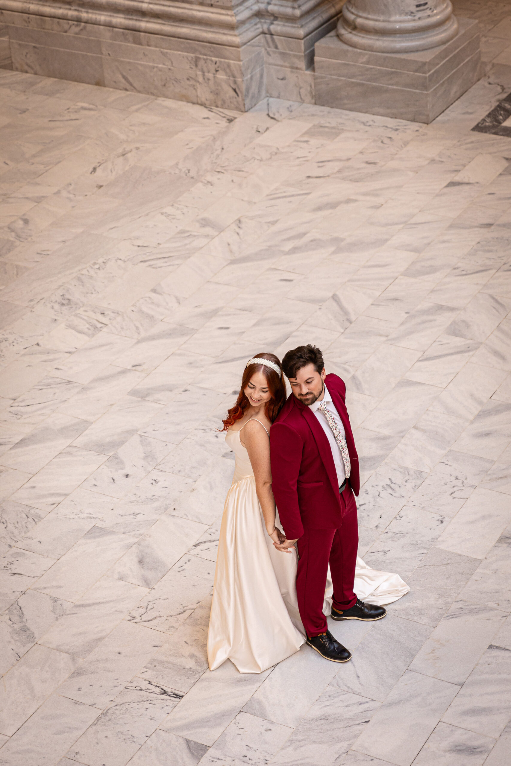 Bride and groom standing in the grand marble hall of the Utah State Capitol during their Salt Lake City courthouse elopement.
