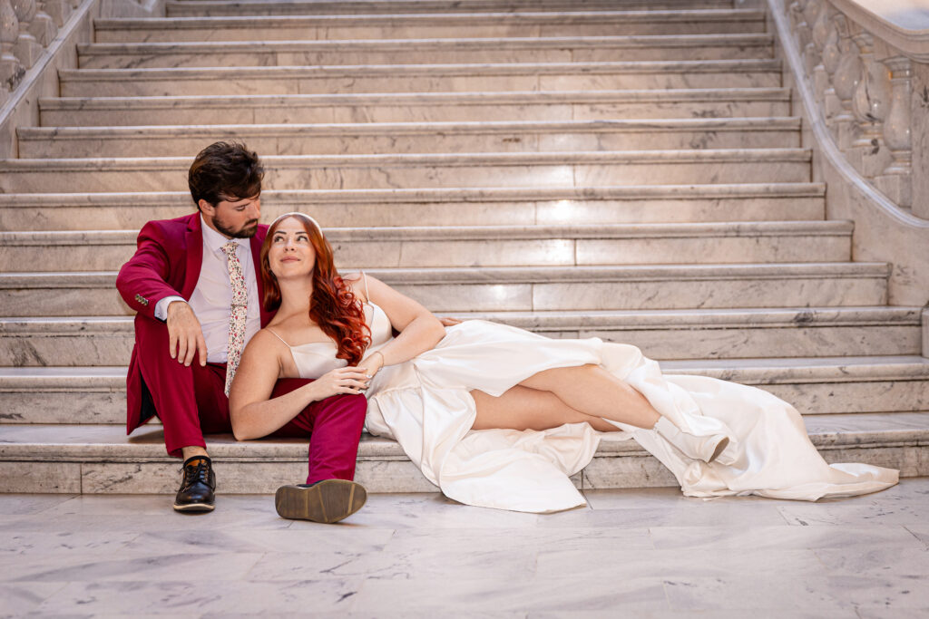 Bride smiling at the groom on the staircase of the Utah State Capitol — elegant courthouse wedding portraits.