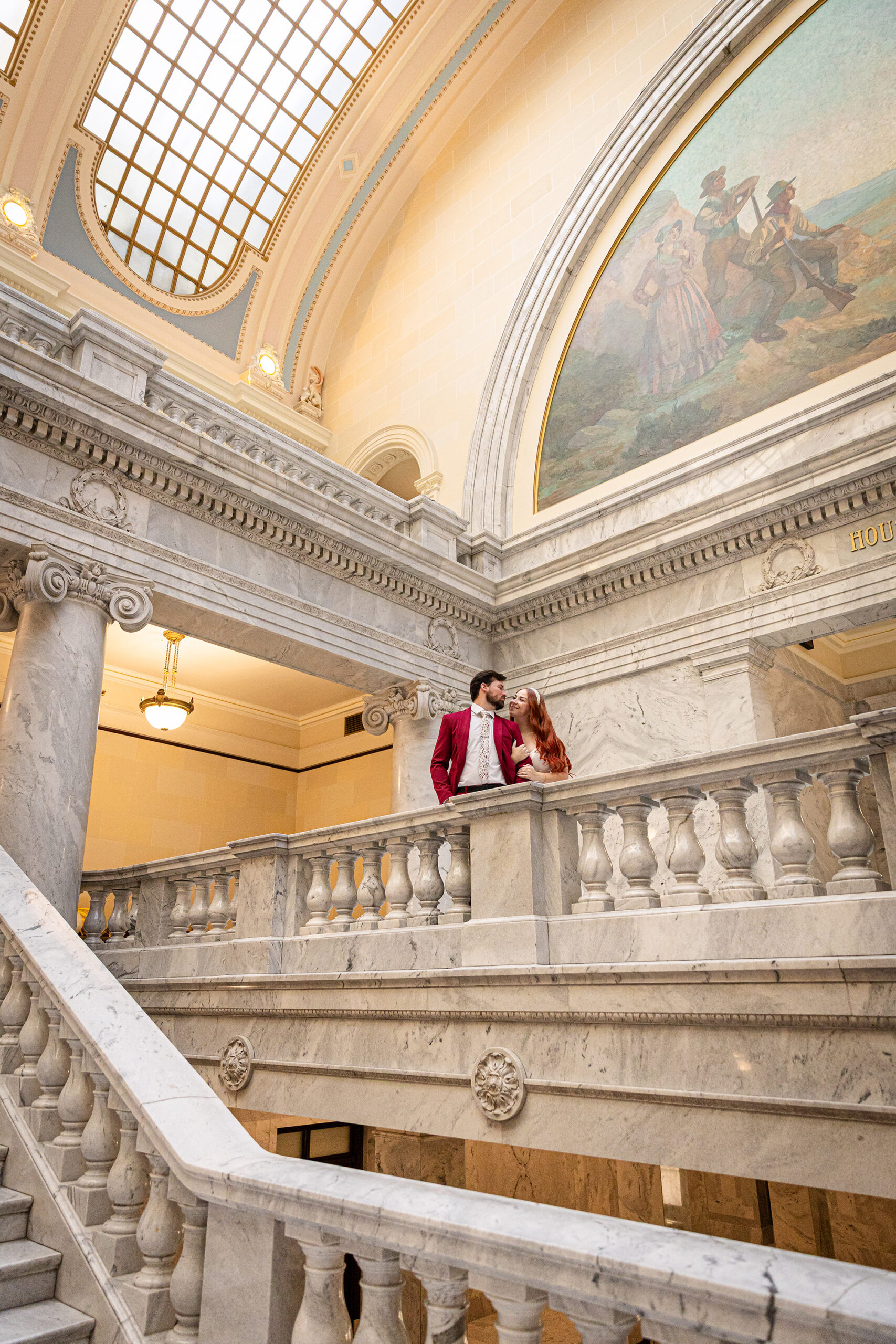 Bride and groom posing beneath the grand dome — cinematic Utah State Capitol elopement session.