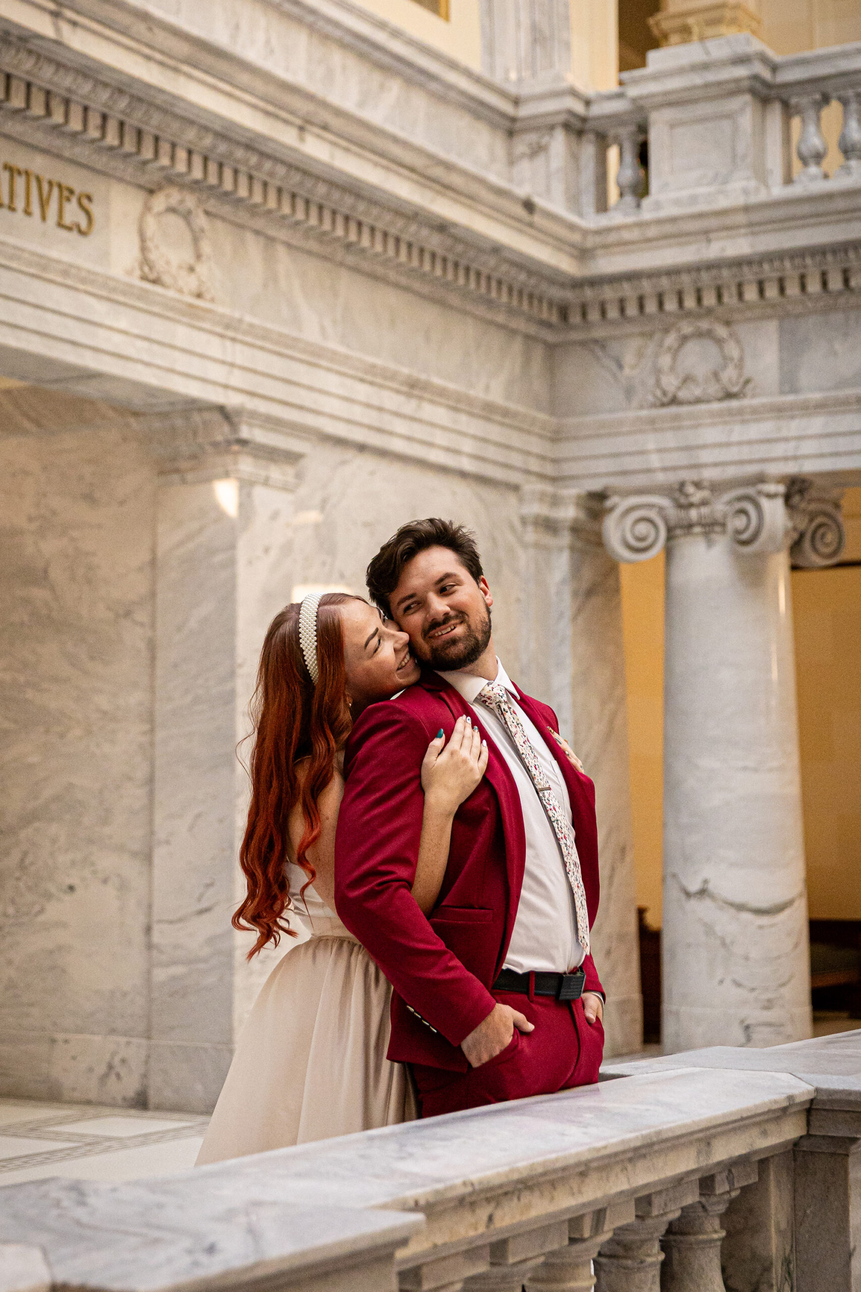 Bride and groom framed by architectural details of the Utah State Capitol during their courthouse formal session.